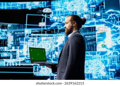 Business administrator uses mockup display next to AI neural networks system, practicing machine learning and cloud computing. Young man implementing artificial intelligence brain.
