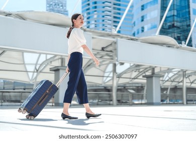 Business adult asian woman walking with luggage for global trip. Female walking at station platform on day. People work and travel concept. - Powered by Shutterstock