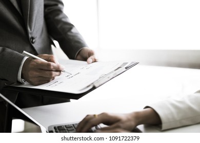 Business adviser analyzing financial figures denoting the progress in the work of the company - Shutterstock ID 1091722379
