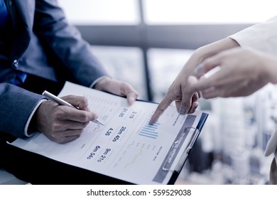 Business Adviser Analyzing Financial Figures Denoting The Progress In The Work Of The Company