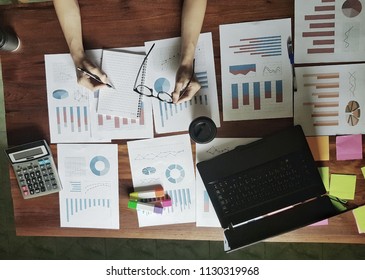 Business analysis graphs and hold the glasses, top view. - Shutterstock ID 1130319968