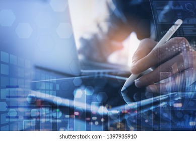 Business analysis, modern technology concept. Finance analyst working at office. Multitasking business man use digital tablet, working on laptop, financial graph, computer dashboard on virtual screen - Powered by Shutterstock