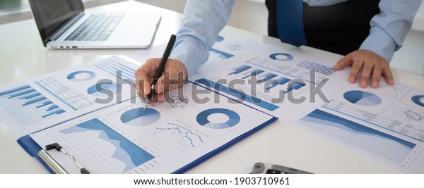 Business\
analyst checking in financial statement for audit internal control\
system. Accounting and Financial\
Concept.