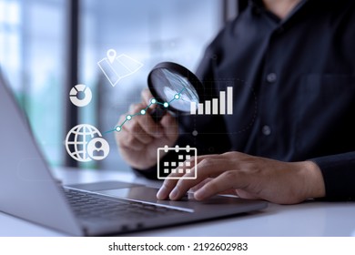 Business analyst with magnifying glass analyzing graphs and charts for market expansion, financial reports, investment data, or sales information concepts. - Powered by Shutterstock