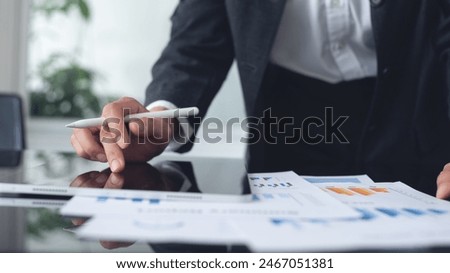 Business analyst using digital tablet analyzing financial statement, business report for audit internal control system. Businesswoman working with business document at office. Accounting and Finance