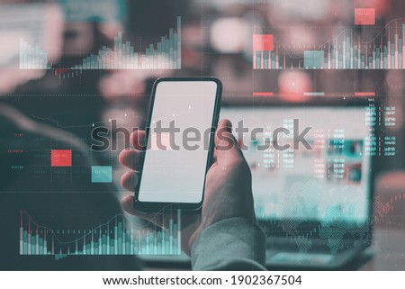 Business analytics with key performance indicators dashboard concept. Man with laptop holds Mockup phone with white screen