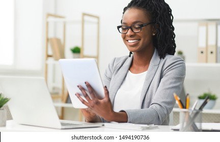 Business App. Afro Woman Using Tablet And Laptop Computer In Office. Free Space For Text