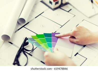 business, architecture, building, construction and people concept - close up of designer hands with color palette and blueprint - Shutterstock ID 619478846
