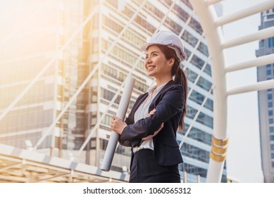 Business Asia Woman Engineer Developer Holding Blueprint Working Confident Outdoors In Construction Site