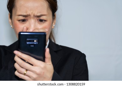 Business Asian Woman In Emotional Sad By Reading In Bad News In Mobile With White Background Or Business Concept