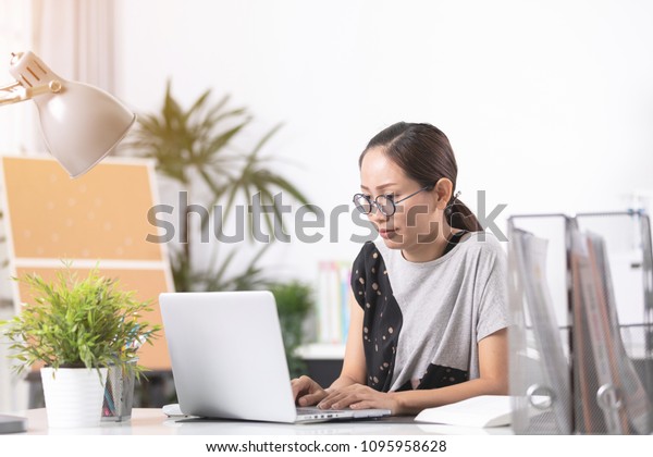 Business asian woman Sad and worried working\
with a laptop in an office,hard work\
concept