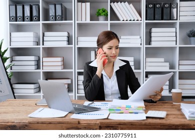 Business asian woman using smartphone for do math finance on wooden desk in office, tax, accounting, financial concept - Shutterstock ID 2310775911