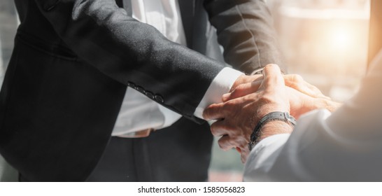 business background of businessman hands holding hands with other in happy conclusion of business deal - Shutterstock ID 1585056823