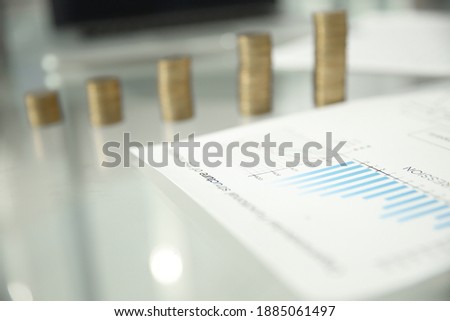 business background. financials and stacks of coins on the offic