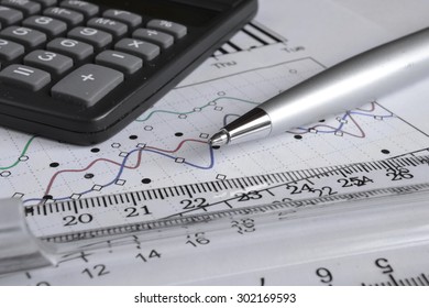 Business background with graph, ruler, pen and calculator.