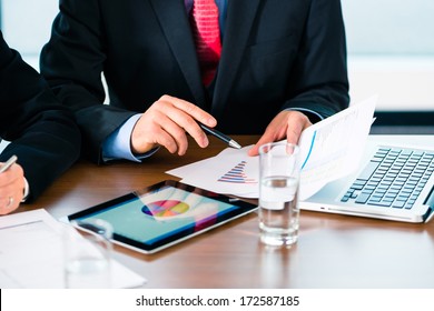Business - banker, Manager or expert evaluates the figures on tablet computer and compares the development of the business in real time
