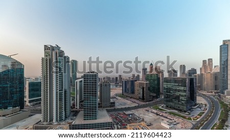 Business Bay Dubai skyscrapers with water canal aerial timelapse at morning during sunrise. Mixed use development with residential and office towers sharing the footprint equally