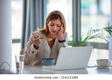 Business Beautiful Happy Woman Working From Home While Having Breakfast With Laptop On The Table. She Is Focused On Work And Does Not Want To Take A Break. Eat At Home.