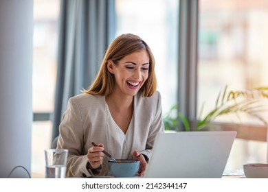 Business Beautiful Happy Woman Working From Home While Having Breakfast With Laptop On The Table. She Is Focused On Work And Does Not Want To Take A Break. Eat At Home.