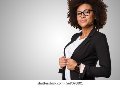 Business Black Woman Adjusting Her Clothes On A Grey Background