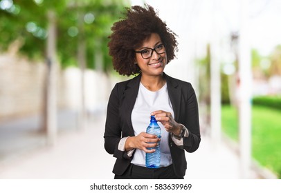 Business Black Woman Holding A Bottle Of Water