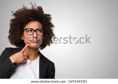 business black woman thinking on a grey background