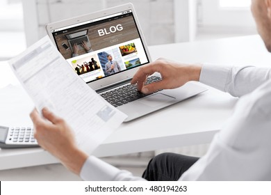 business, blogging, technology and people concept - businessman with internet blog page on laptop computer screen working at office