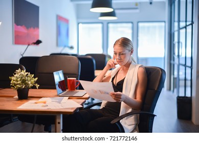 Business Blonde Girl Thinking About Work And Reading A Business Documents