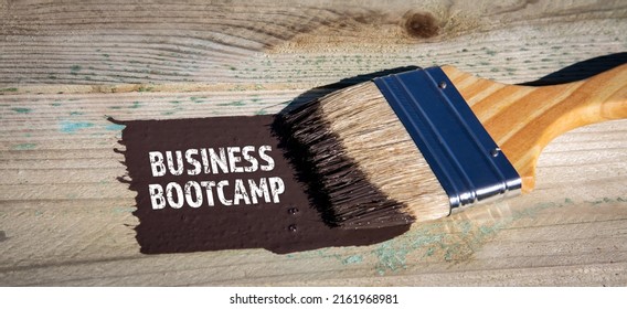 Business Bootcamp. Paint Brush And Brown Paint On A Wooden Background.