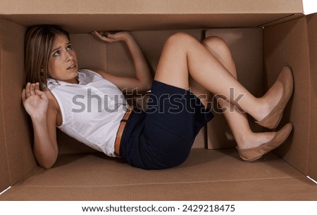 Business, box and fear with woman, scared and claustrophobic with emotion and reaction. Person, employee and entrepreneur with cardboard and anxiety with depression and afraid with fright and crisis