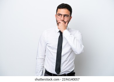 Business Brazilian man isolated on white background having doubts and with confuse face expression - Shutterstock ID 2196140057