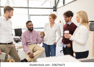 Business, Break, Communication And People Concept - Happy Creative Team Drinking Coffee And Talking At Office