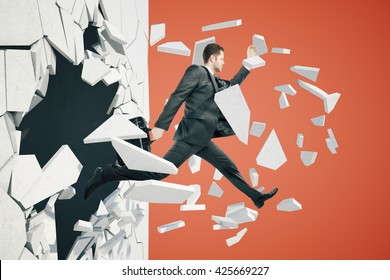 Business Breakthrough Success Concept With Businessman Jumping Through Wall On Red Background