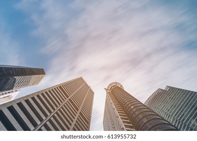 Business Buildings Skyline Looking Up With Blue Sky Background. High-rise Skyscraper, Modern Architecture.