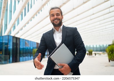 Business. Businessman Giving Hand For Handshake Welcome Gesture Adult Hispanic Male Business Person Holding Document Paper Give Hand Ready Handshake Office Building Background