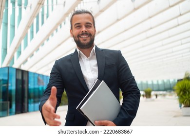 Business. Businessman Giving Hand For Handshake Welcome Gesture Adult Hispanic Male Business Person Holding Document Paper Give Hand Ready Handshake Office Building Background