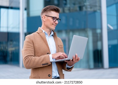 Business. Businessman Using Laptop Outdoor Adult Caucasian Male Business Person Eyeglasses Dressed Hipster Jacket Outside Smiling Happy Positive Emotions Sunlight Background Big City Street