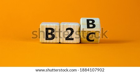 Business to Business or Busness to Consumer. Turned a cube and changed the expression 'B2C' to 'B2B' or vice versa. Business concept. Beautiful orange background, copy space.
