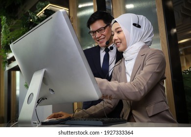 Business Call Center Or Customer Service With Muslim Woman Operator Trainee And Supervisor Training Or Coaching In Font Of The Computer