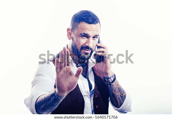 Business call. Man well groomed rich\
fashionable macho. Clothes and accessories. Fashion macho. Mobile\
conversation. Bearded guy white background. Mafia boss. Guy\
handsome mafia boss hold\
smartphone.