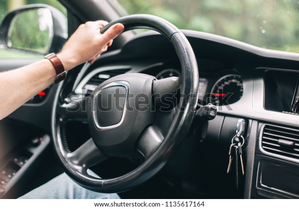 business car driver. Hands on the steering wheel\
while traveling behind the\
wheel.