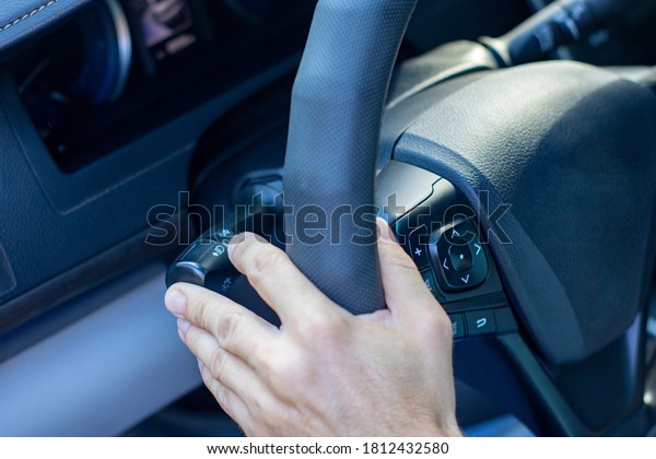 Business car driver. Man\'s hand holding the steering\
wheel in a car