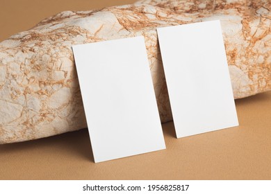 Business Card Against Bright Sand Stone. Mock Up.