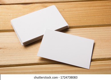 Business Card Blank On Wooden Background. Corporate Stationery, Branding Mock-up. Creative Designer Desk. Flat Lay. Copy Space For Text