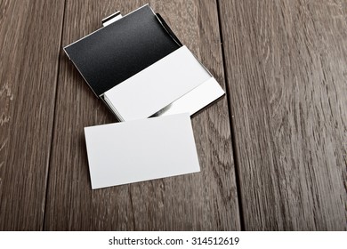 Business Card And Cardholder On Wooden Table
