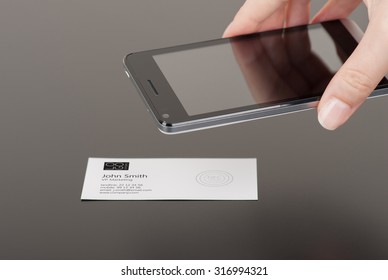 Business Card With Embedded NFC Tag And A Phone