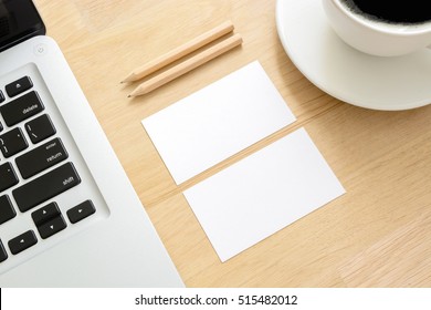 Business Card Mockup With Laptop And Coffee Cup On Wooden Table