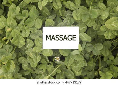 Business Card On MASSAGE Written On Green Grass Background, Top View