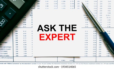 The business card with the text Ask The Expert is on the financial documents. Calculator and pen. Can be use as a financial and business concept
