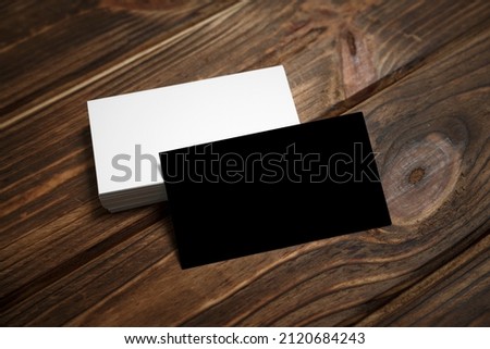 Business cards blank. White and black mockup on wooden background. Flat Lay. copy space for text